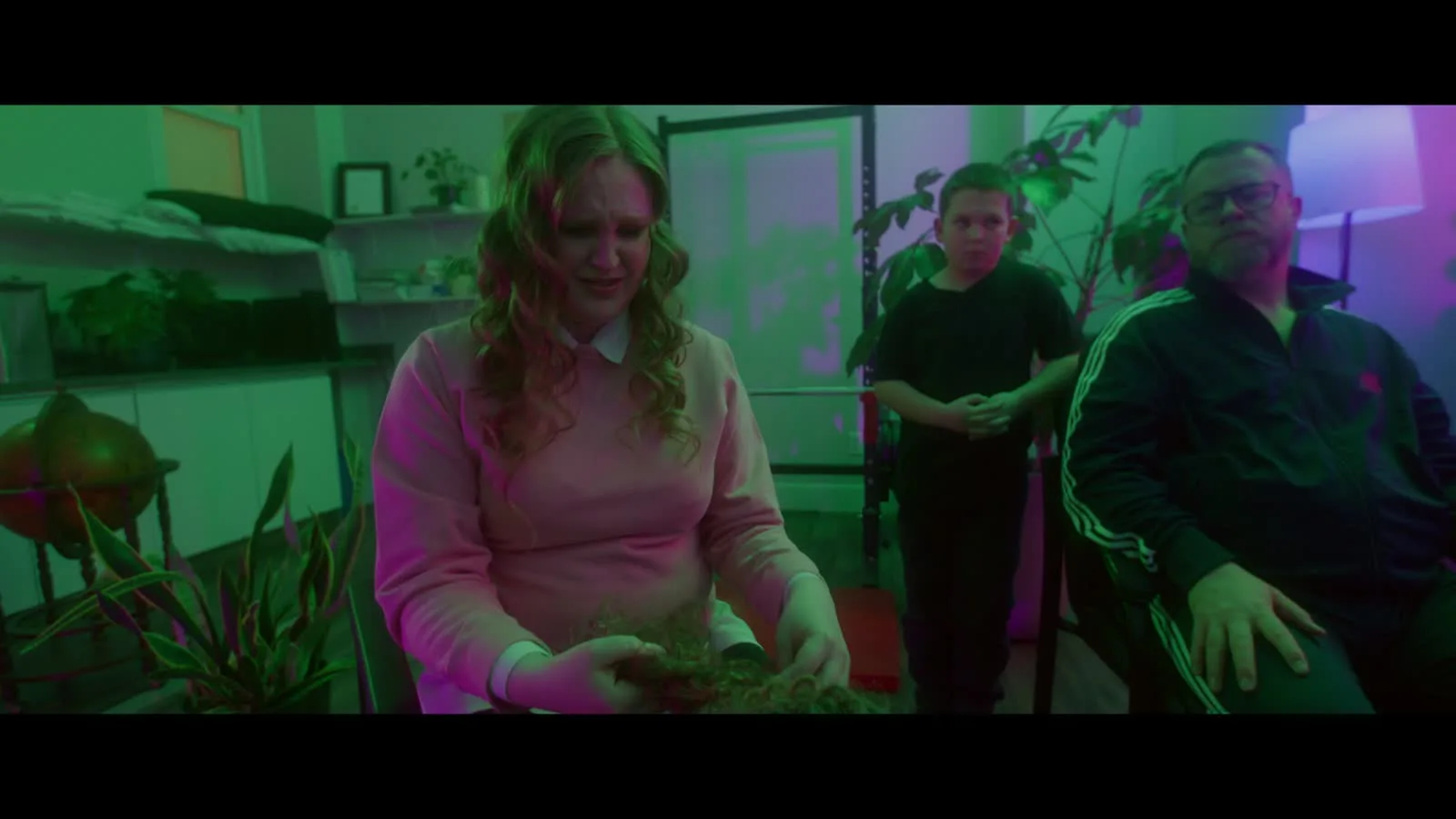 A saturated green and magenta finished-film frame from Midlife Shuffle.